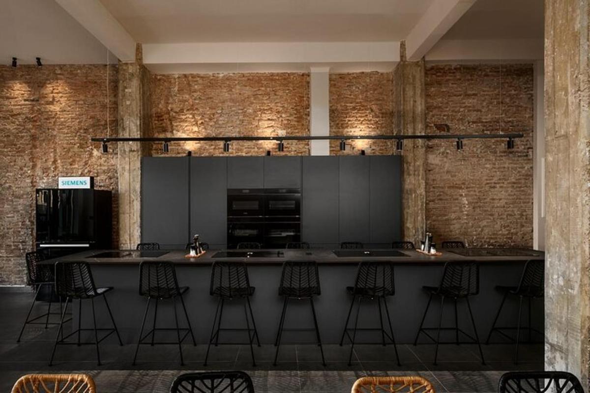 a kitchen with a large counter with bar stools