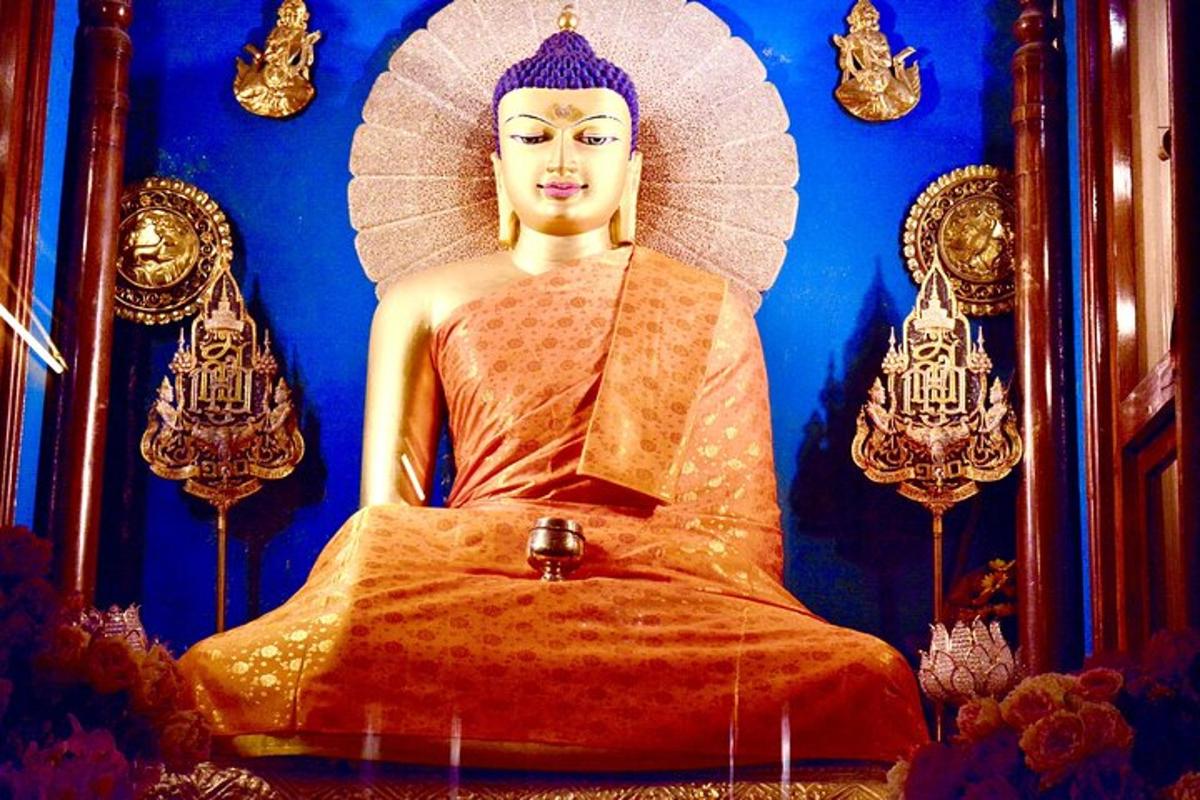 a statue of a buddha sitting in a chair