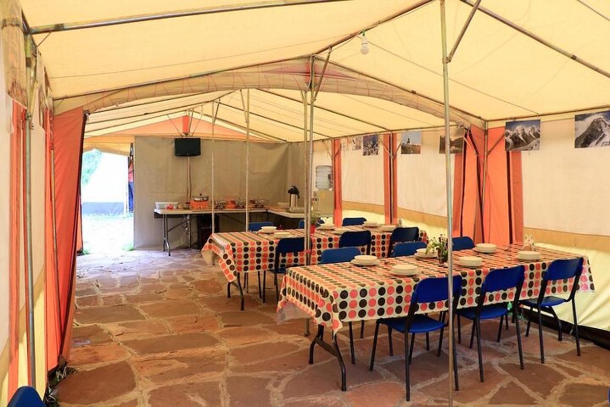 a tent with tables and chairs in a room