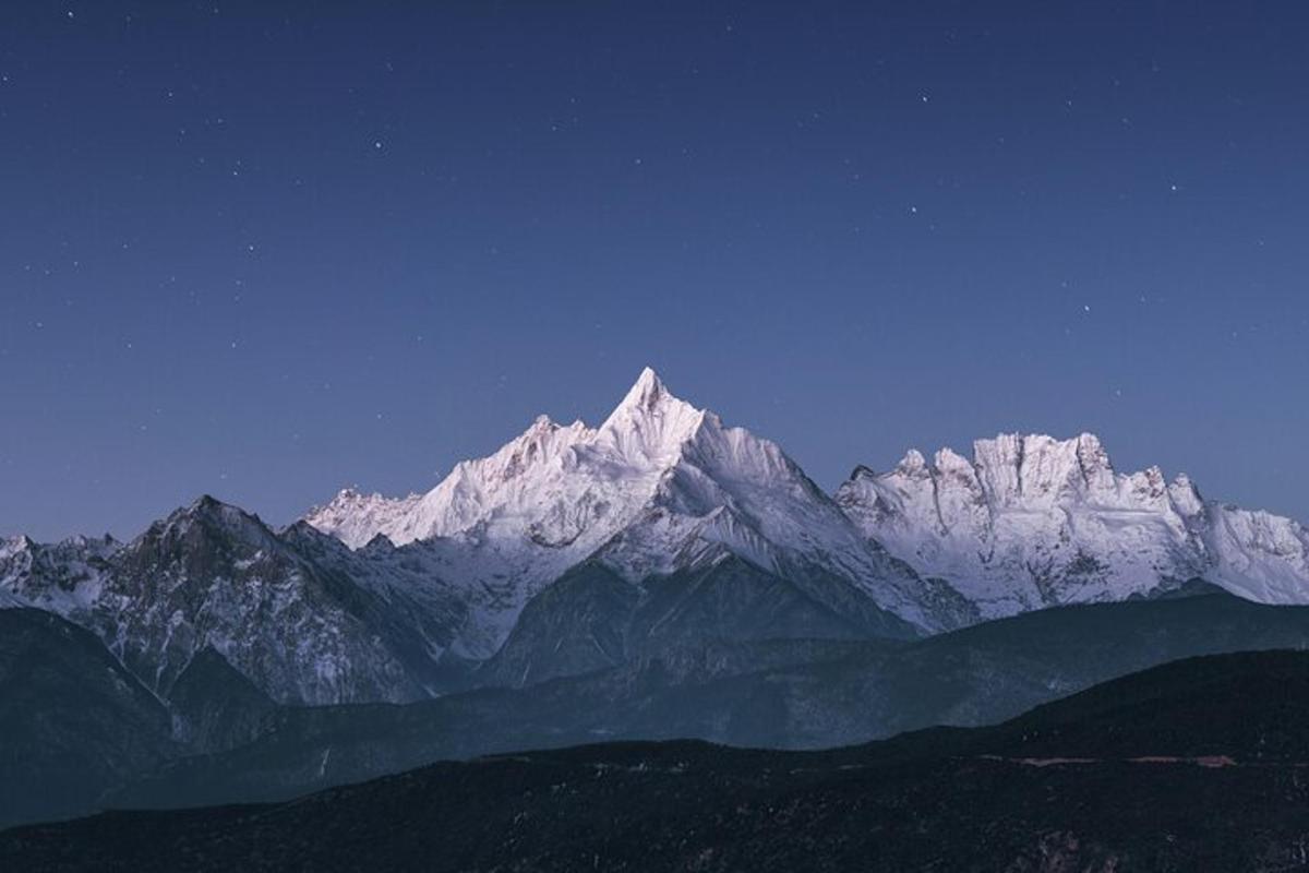 a view of a mountain range with snow covered mountains