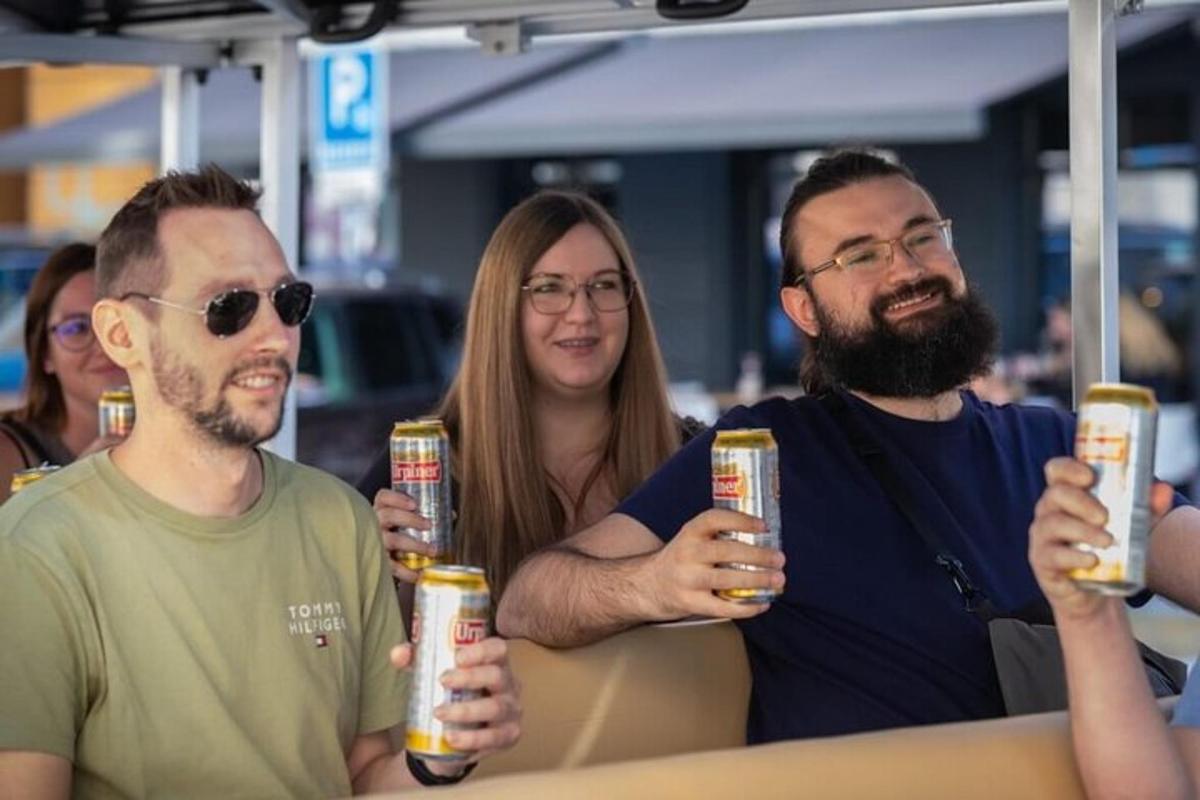 a group of three people holding up beer cans