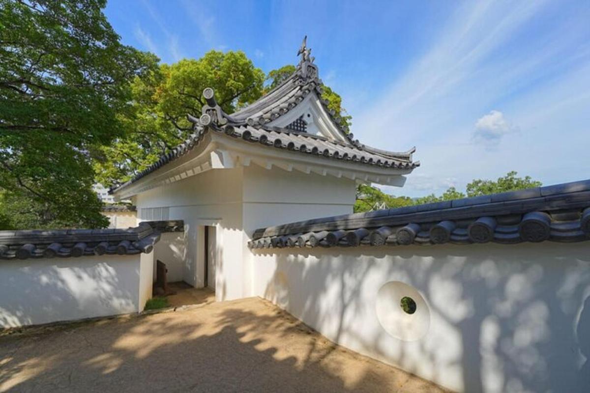 a white building with a roof on a wall