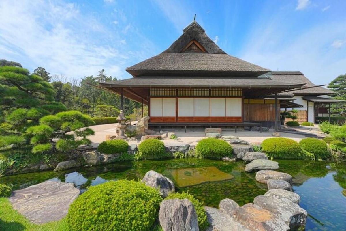 a building with a pond in front of a garden