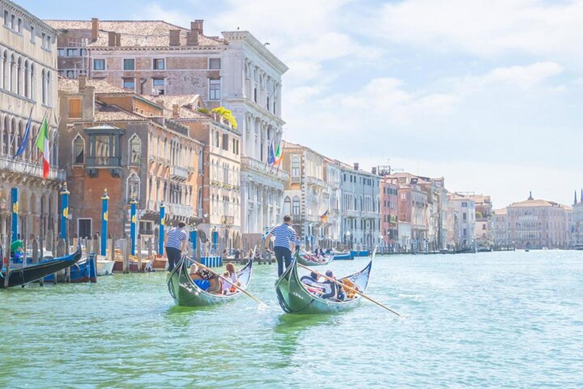 two people on gondolas in the water in a canal