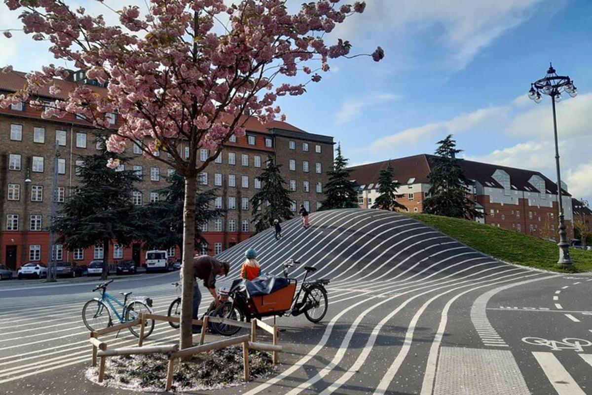a man sitting on a bench next to a tree