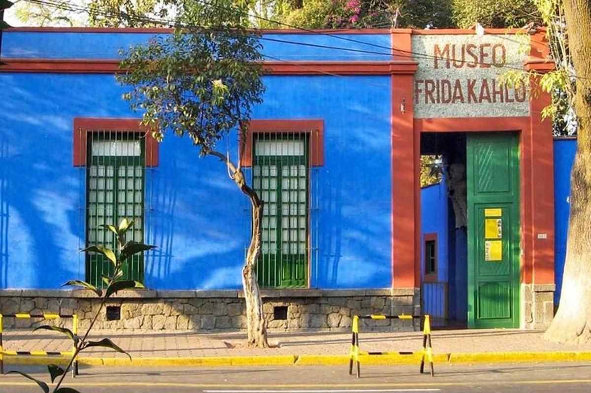 a blue building with green doors on a street