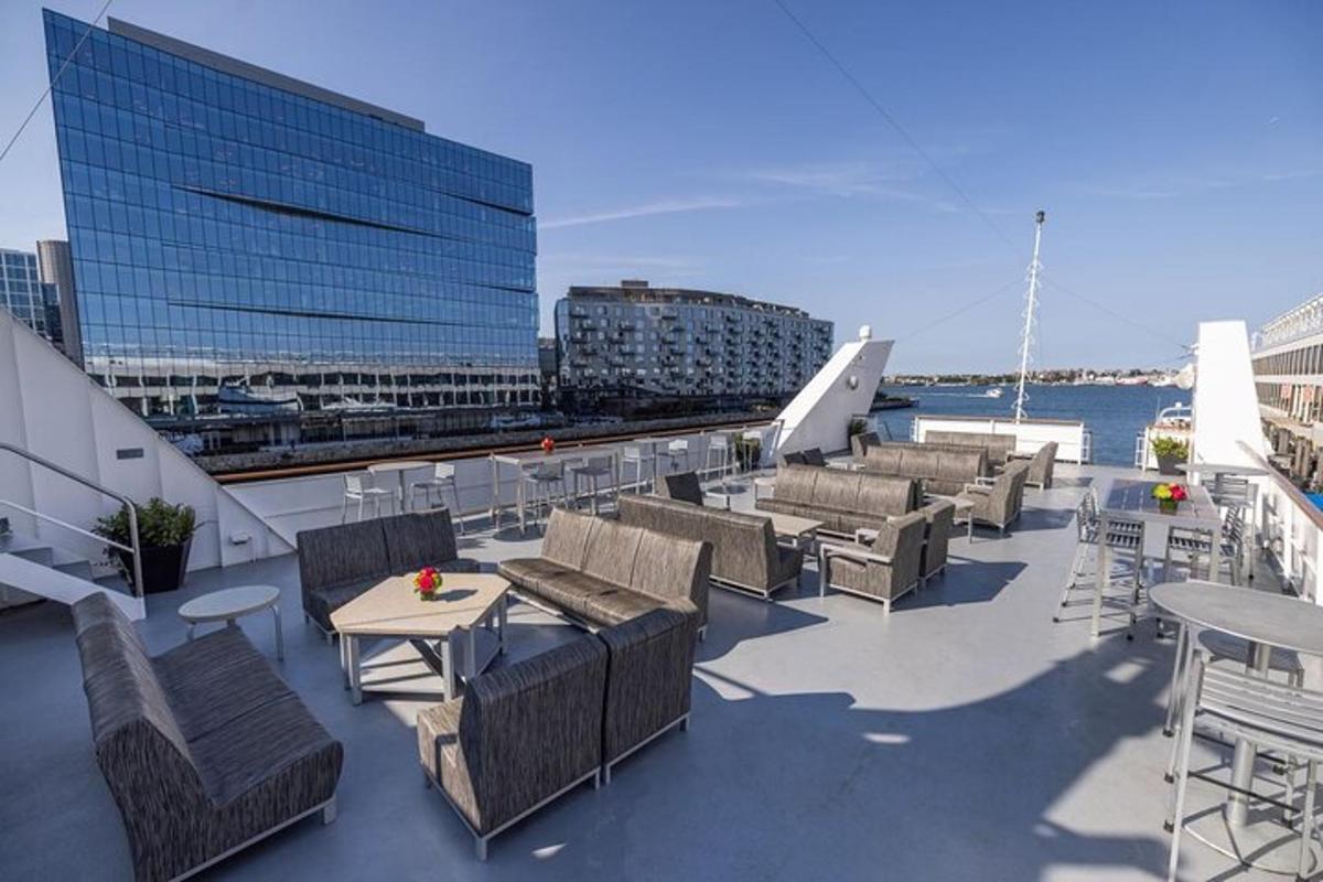a balcony with chairs and tables and a building