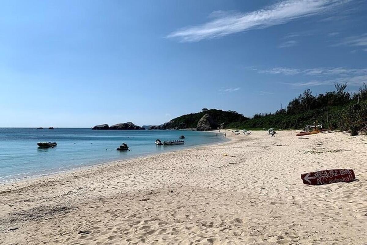 a sandy beach with boats in the water