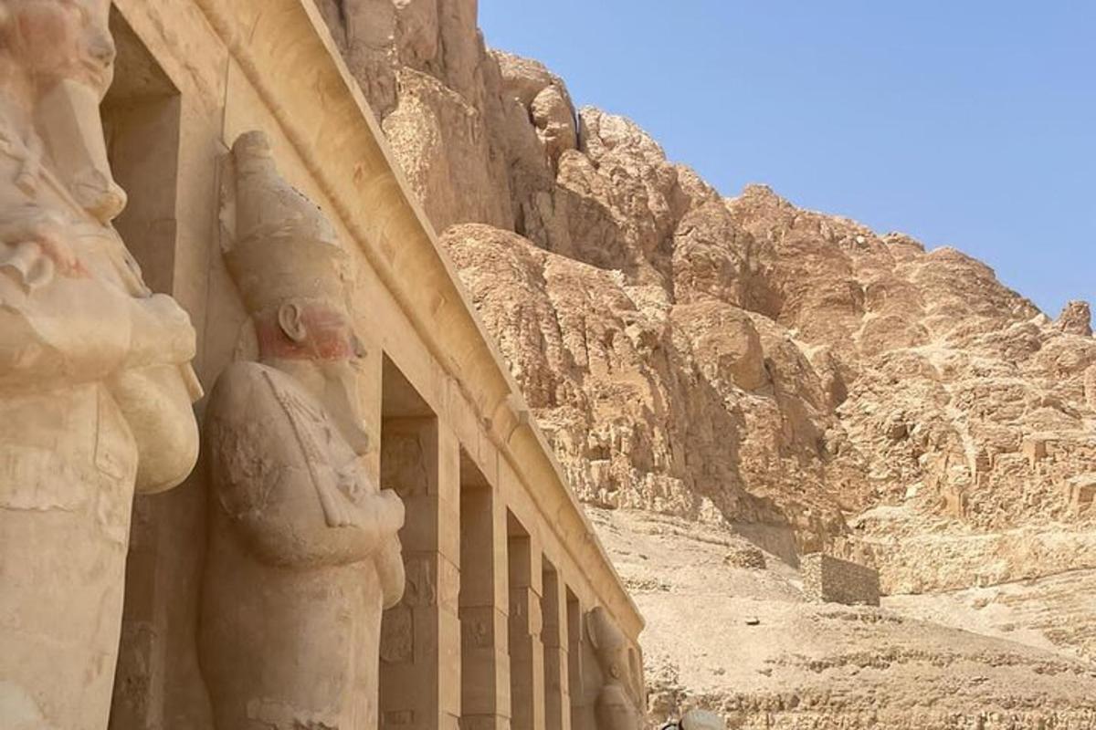 a building with statues on the side of a mountain