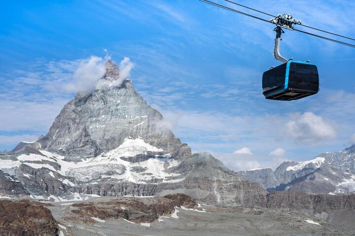 a ski lift in front of a mountain