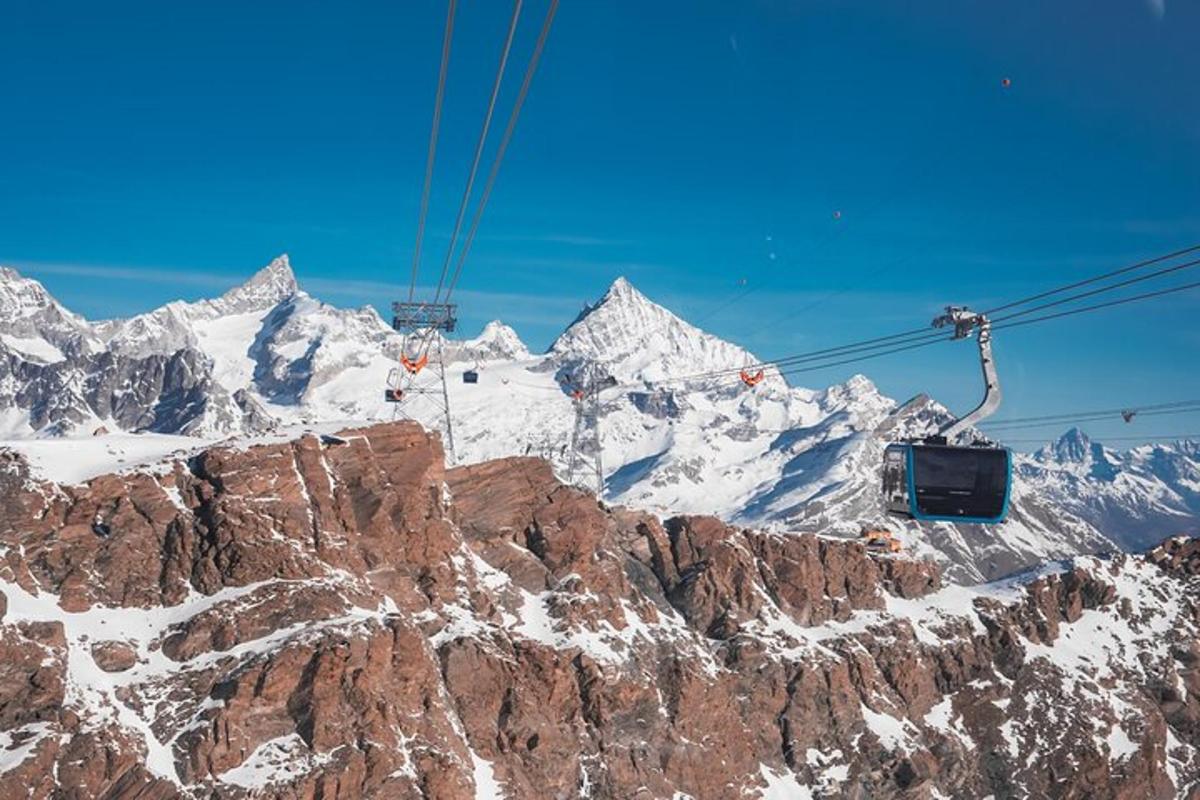 a ski lift over a snow covered mountain
