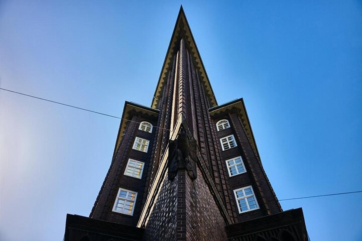 a tall building with a steeple on a blue sky