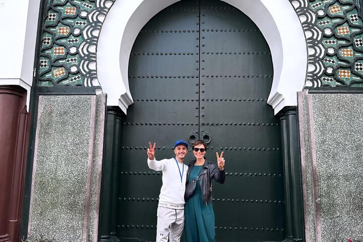 two people standing in front of a building
