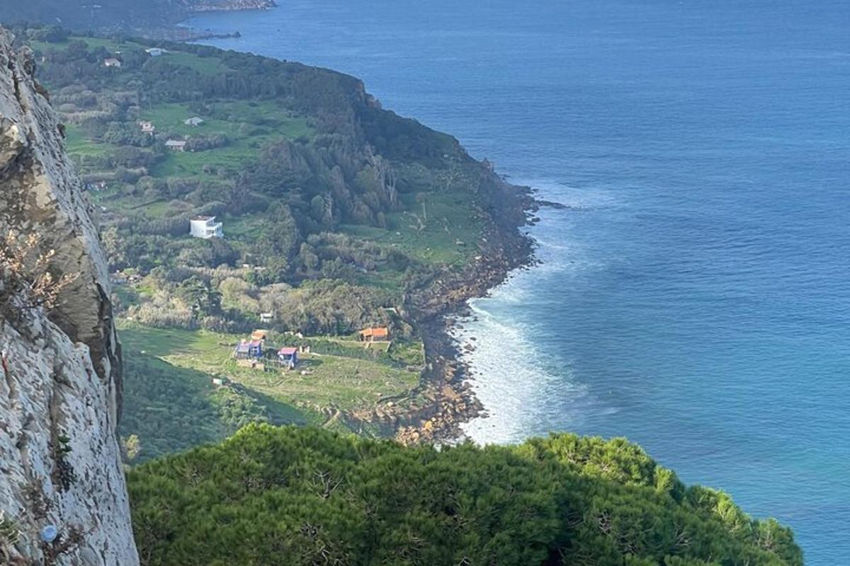 an aerial view of a mountain with the ocean