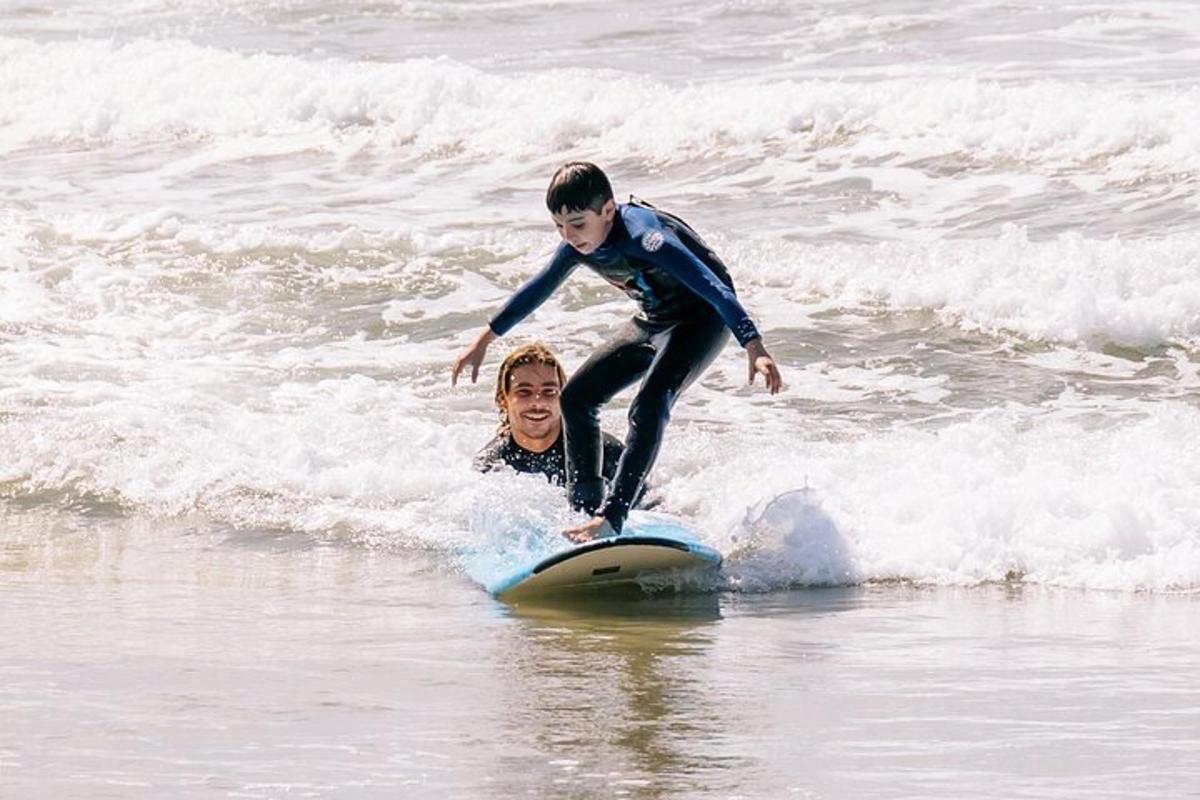 a young boy riding on a surfboard in the ocean