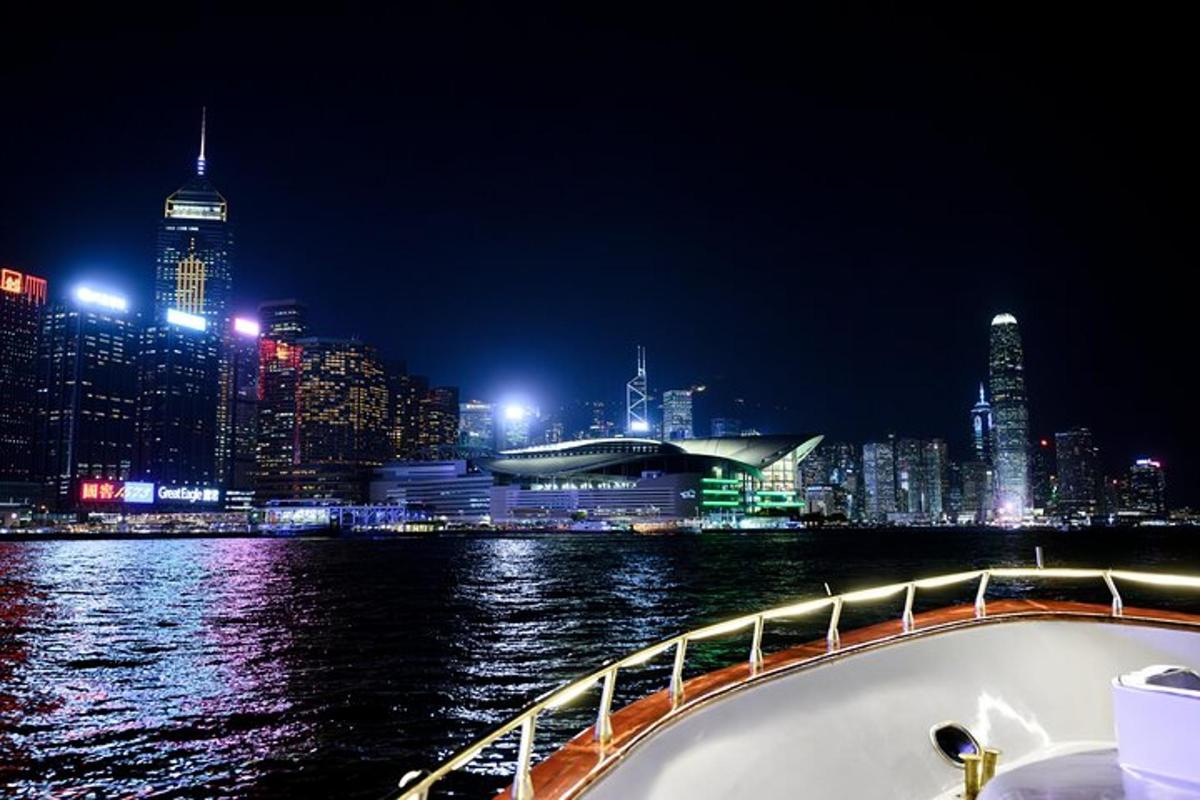a boat on the water with a city at night