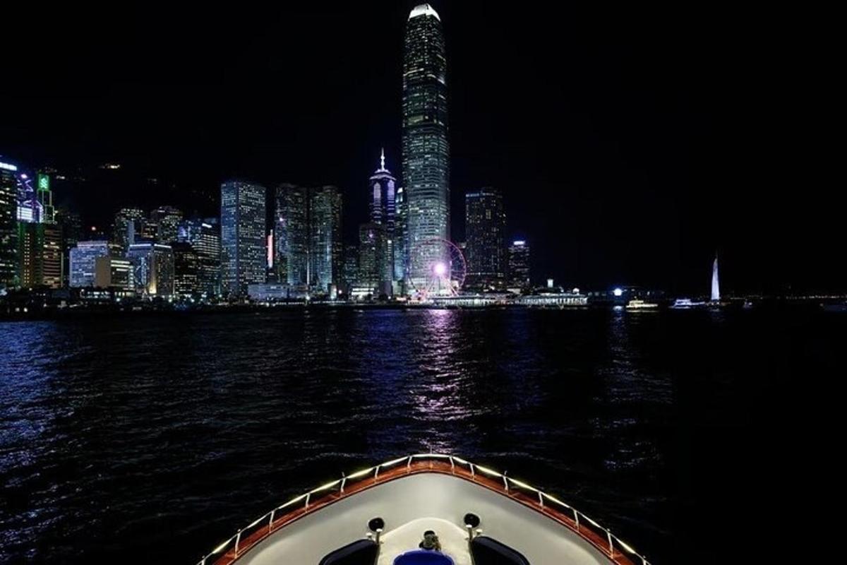 a boat in the water with a city at night