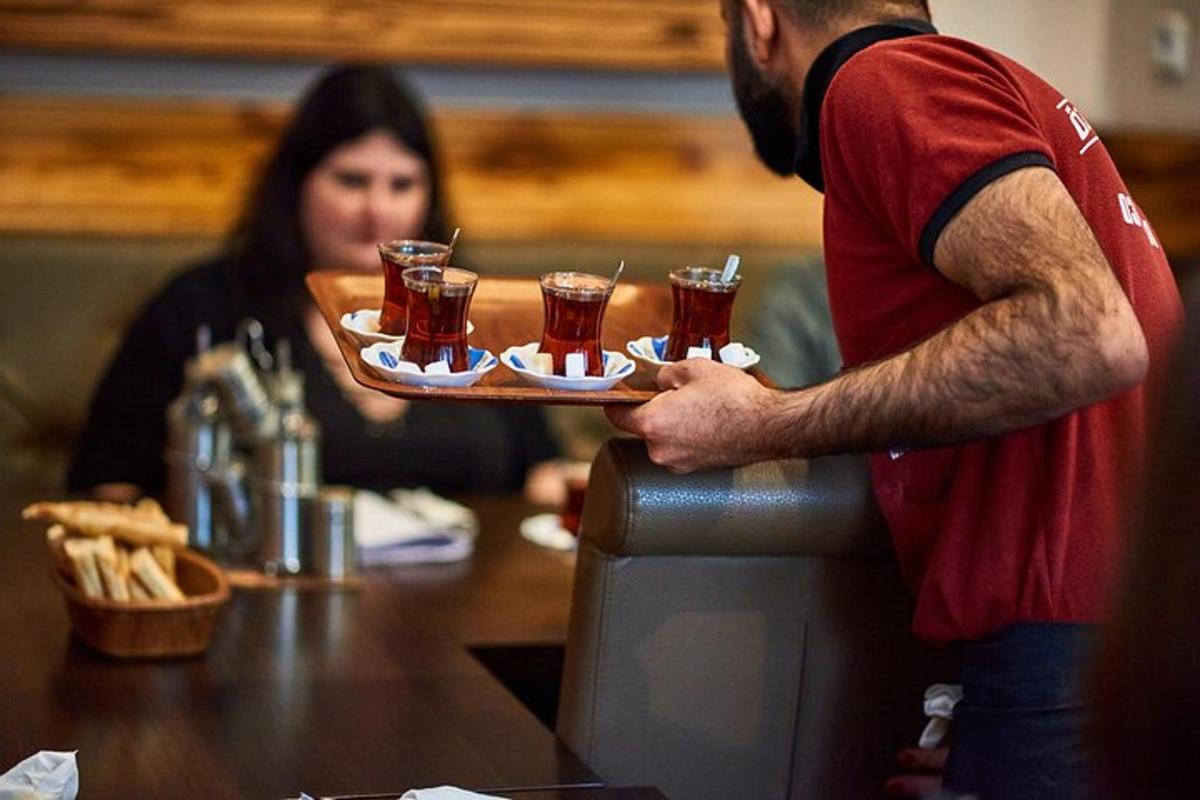 a man holding a tray of glasses of beer