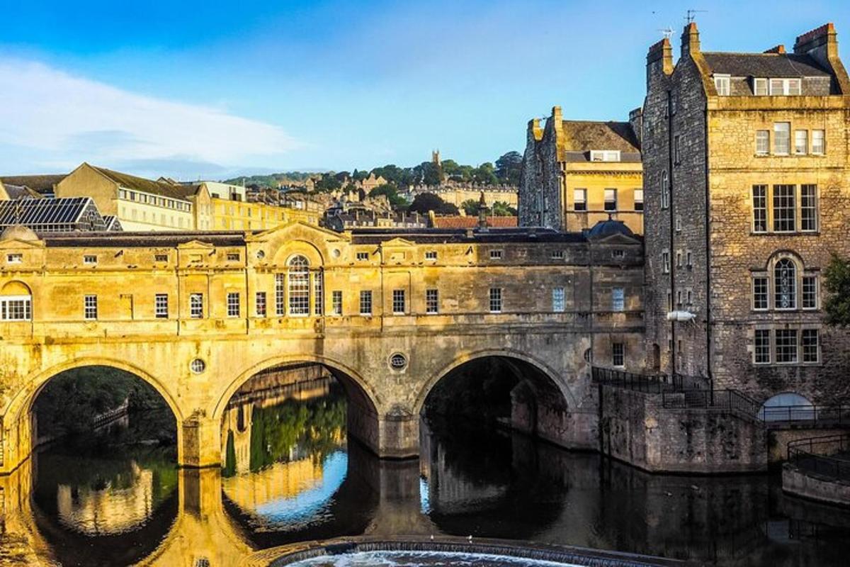 an old bridge over a river in a city