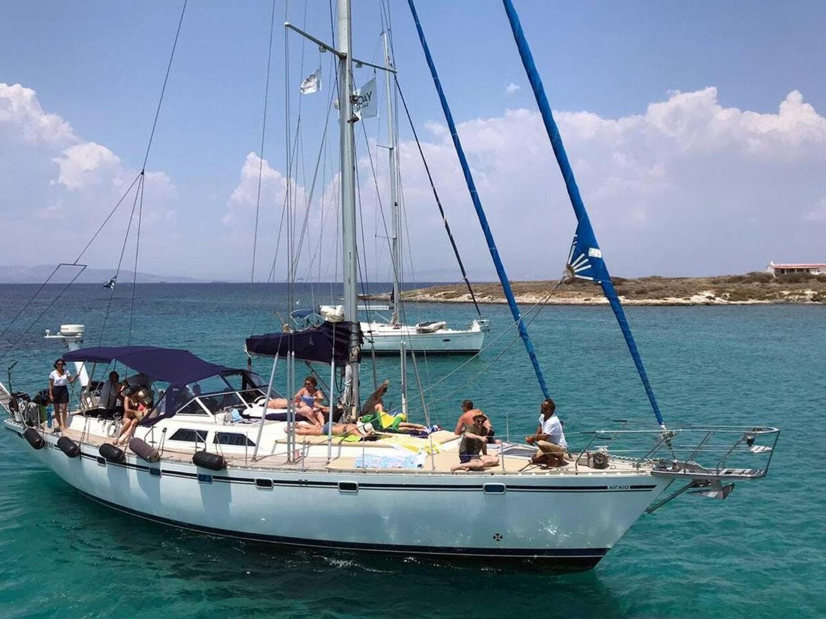 a group of people sitting on a sail boat in the water