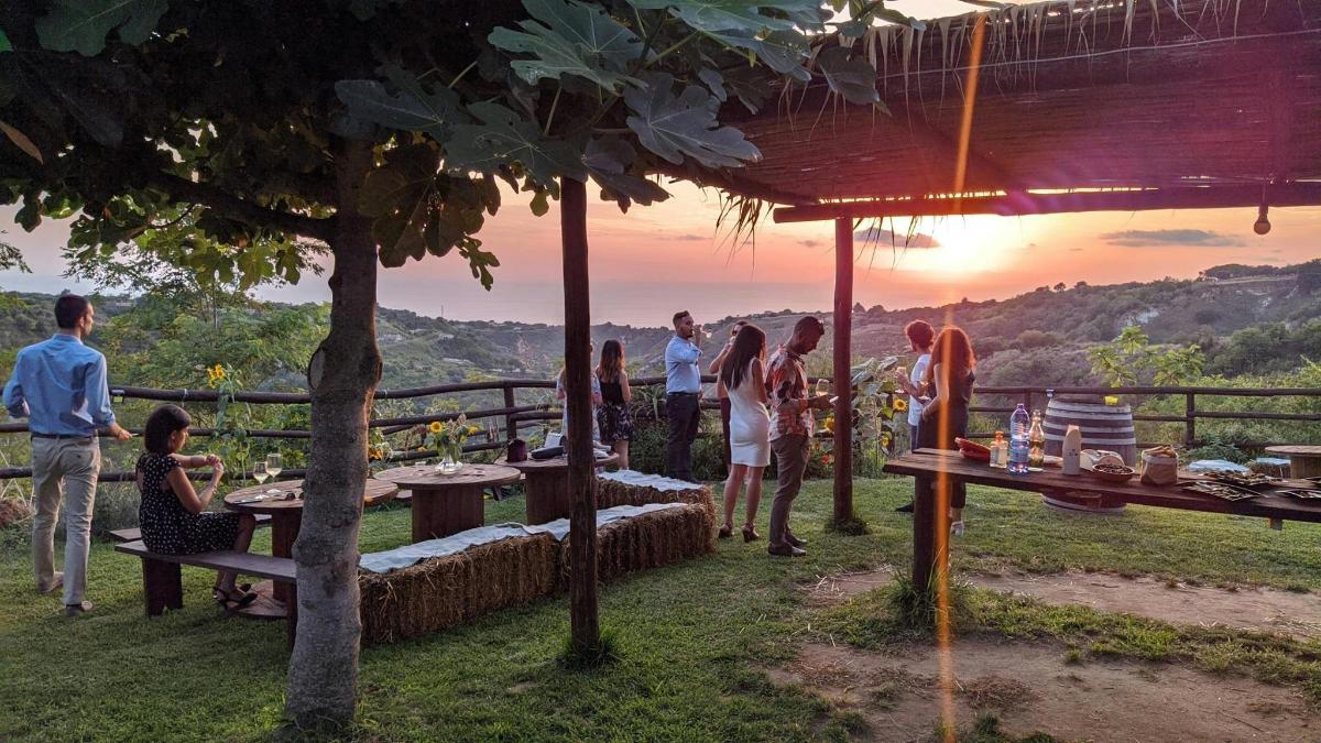 a group of people standing around a table with a view