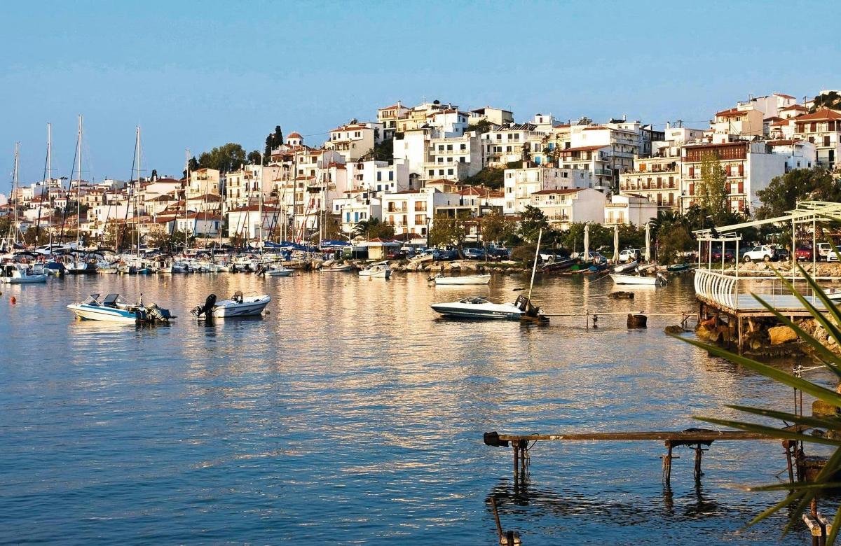 a group of boats in a harbor with buildings