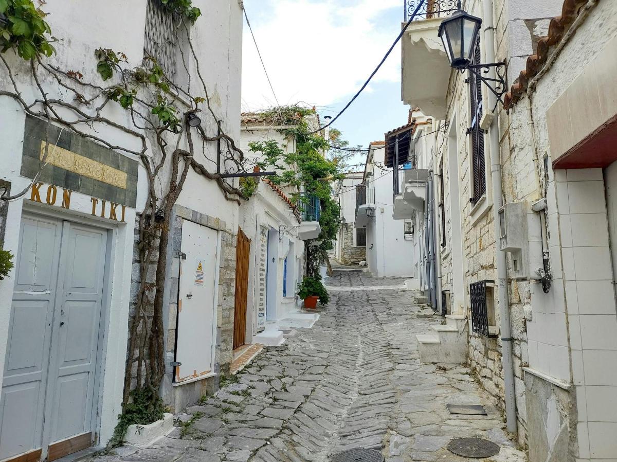 an alley in an old town with white buildings