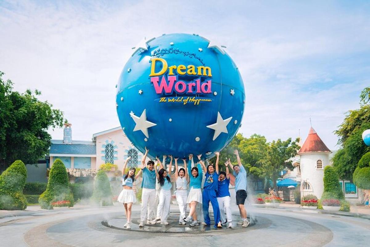 a group of people holding a blue balloon at dream world