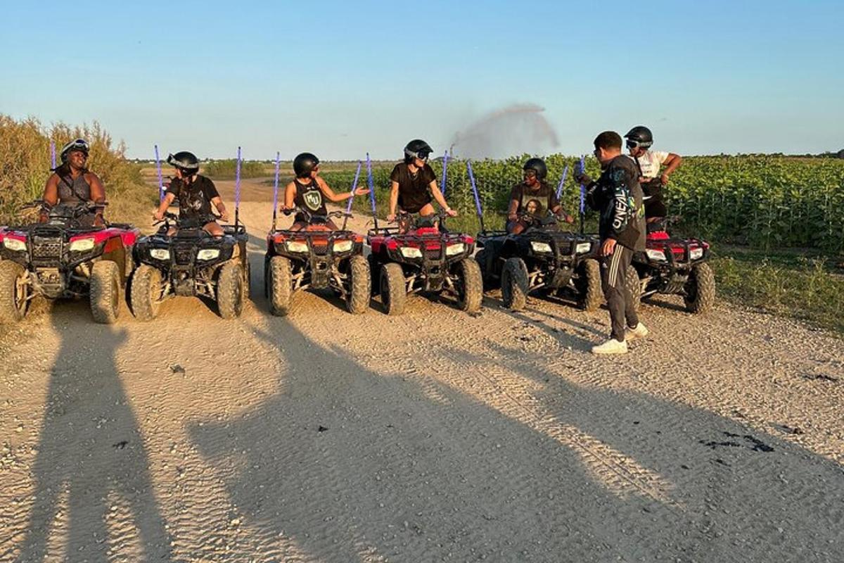 a group of people riding atvs on a dirt road