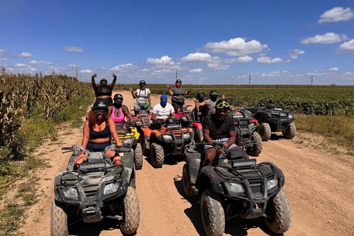 a group of people riding atvs on a dirt road
