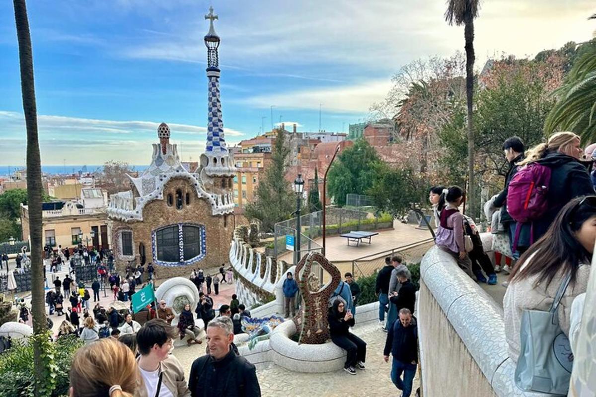 a crowd of people standing on a fence near a tower