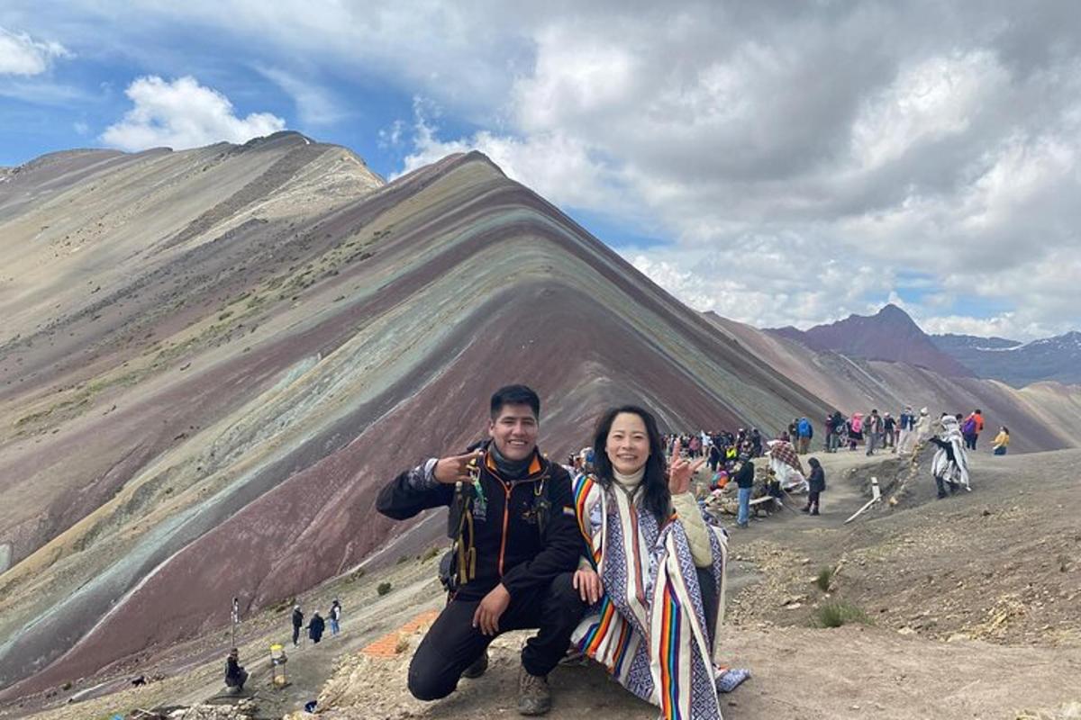 a man and woman posing in front of a mountain
