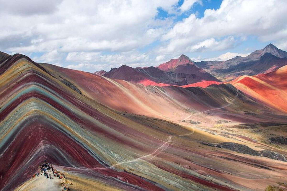 a painting of a desert with mountains in the background
