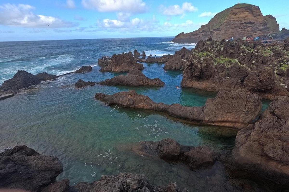 an aerial view of rocks in the ocean