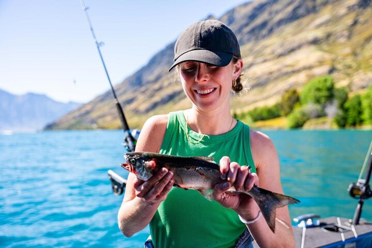a woman holding a fish in her hands on a boat