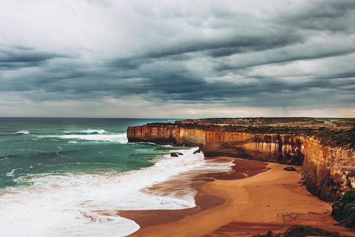 a view of a beach with a cloudy sky and the ocean
