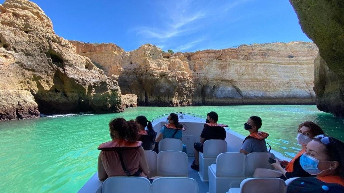 a group of people on a boat in a cave