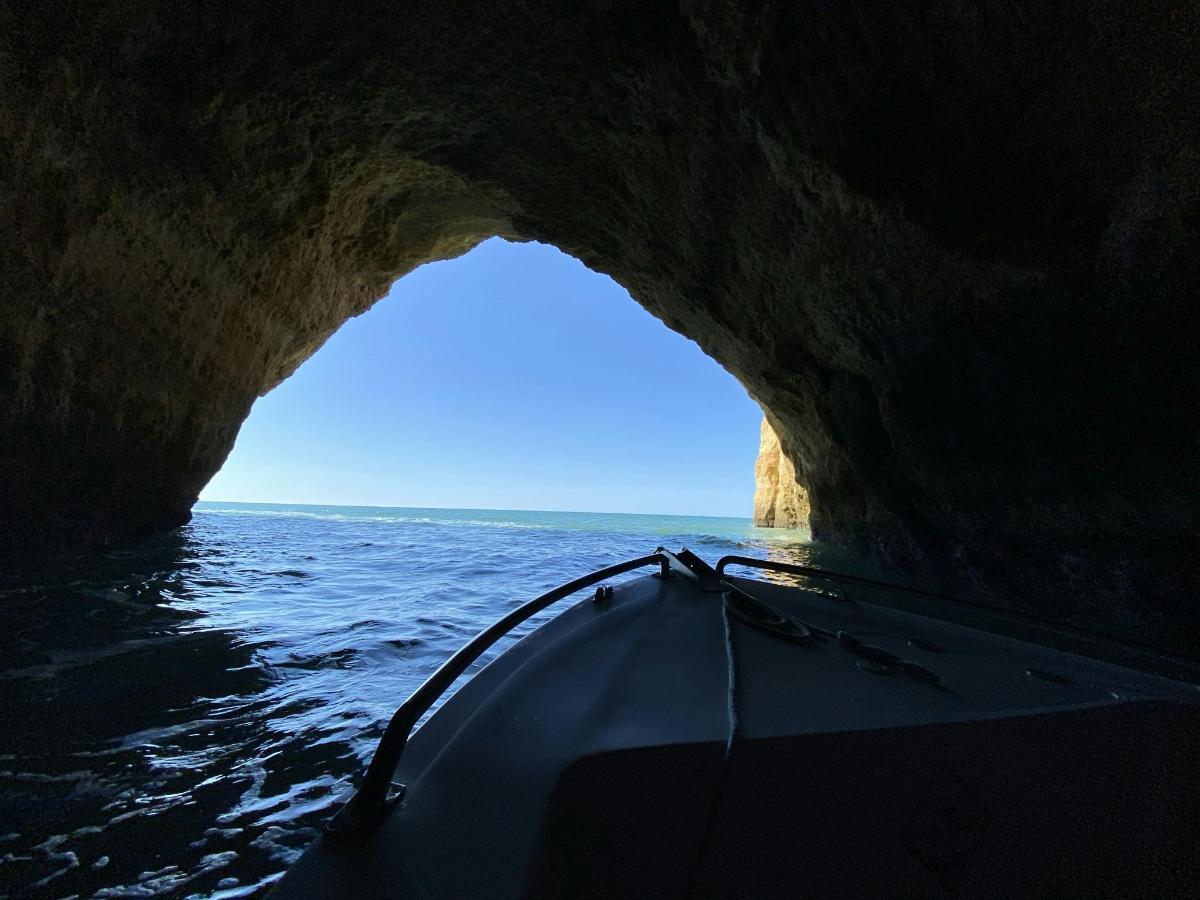 a person in a kayak going through a cave