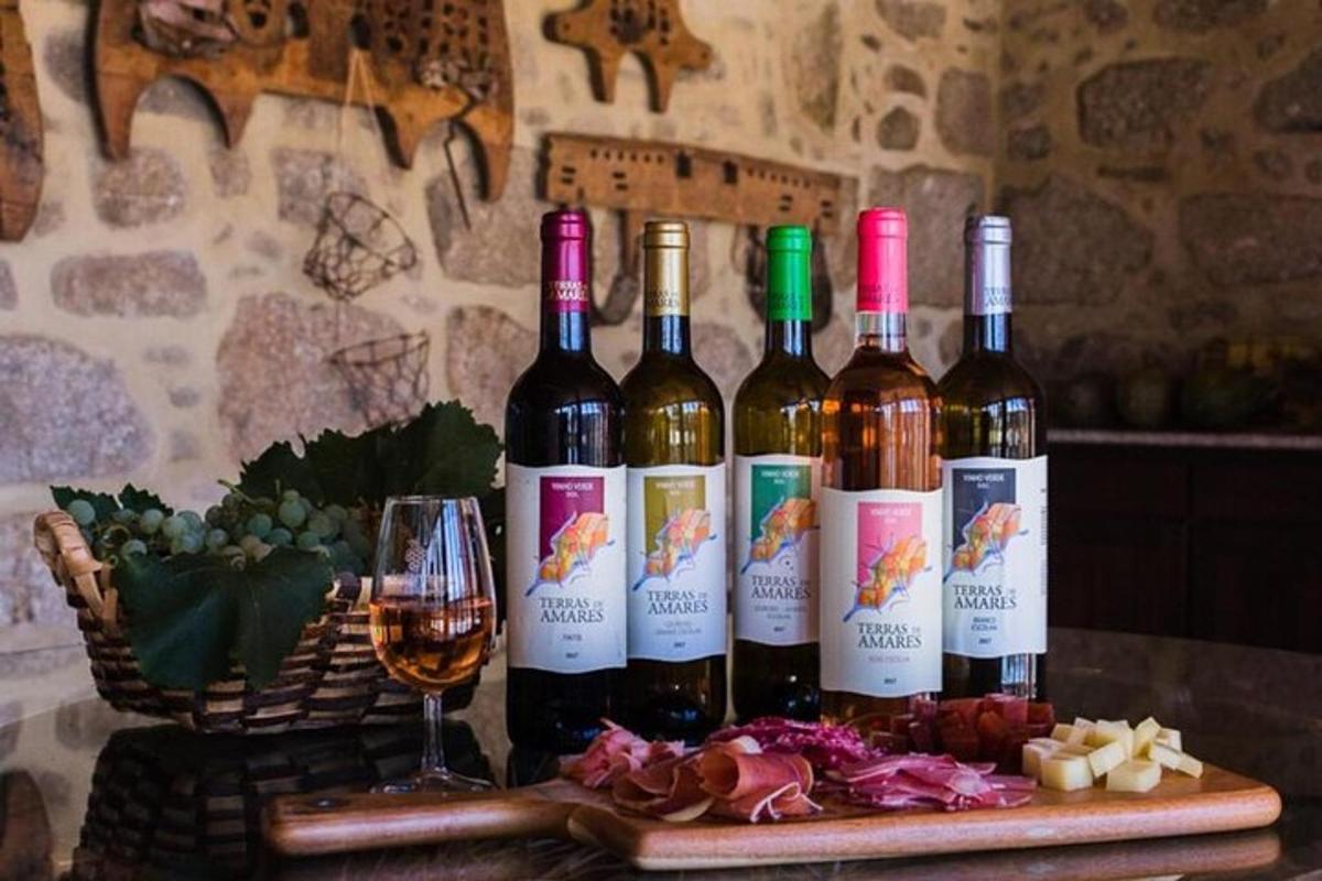 a group of wine bottles on a table with a glass