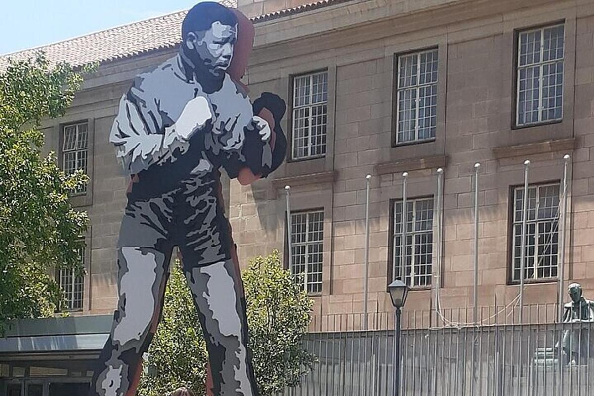 a statue of a man standing in front of a building