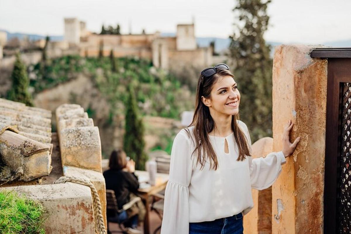 a woman standing next to a wall in front of a city