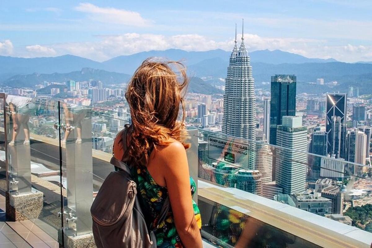 a woman standing on a balcony looking at a city