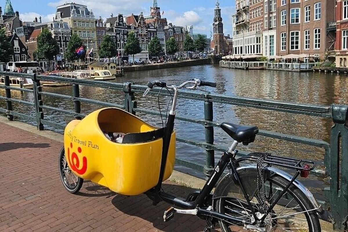 a bicycle with a yellow basket on the side of a river