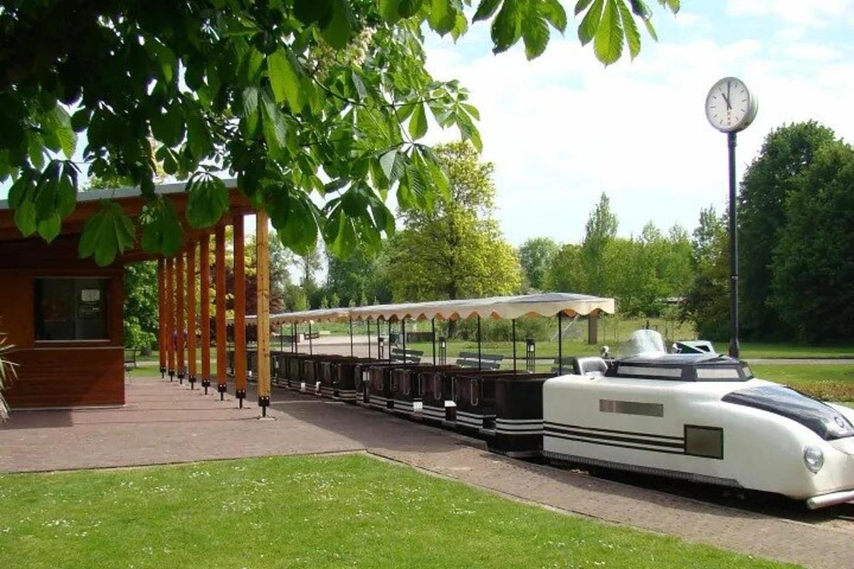 a small train is parked next to a building