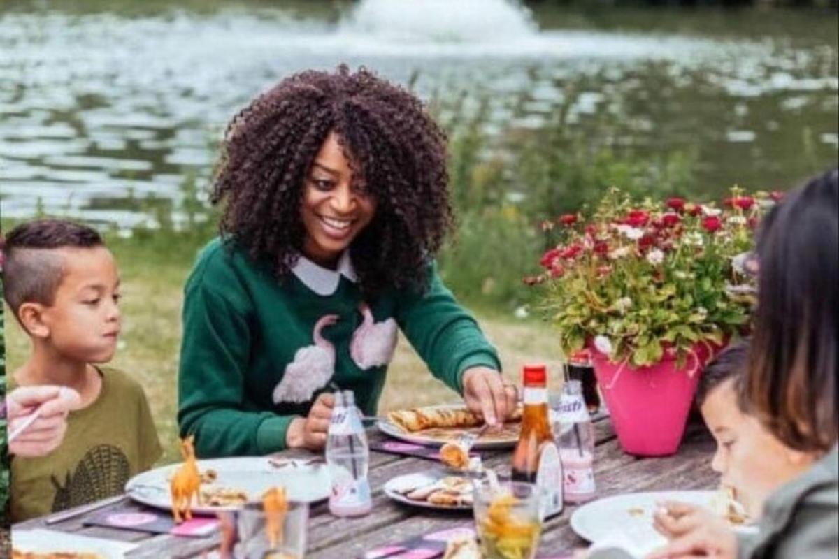 a woman sitting at a table eating food