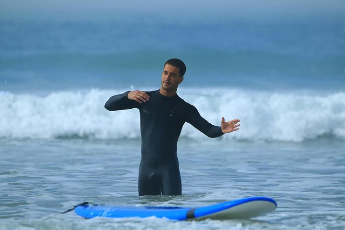 a man standing on a surfboard in the ocean