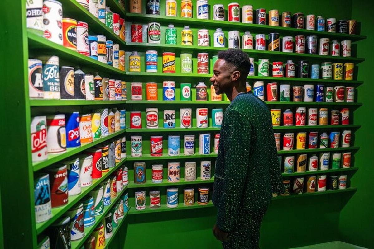 a man standing in front of a shelf of food