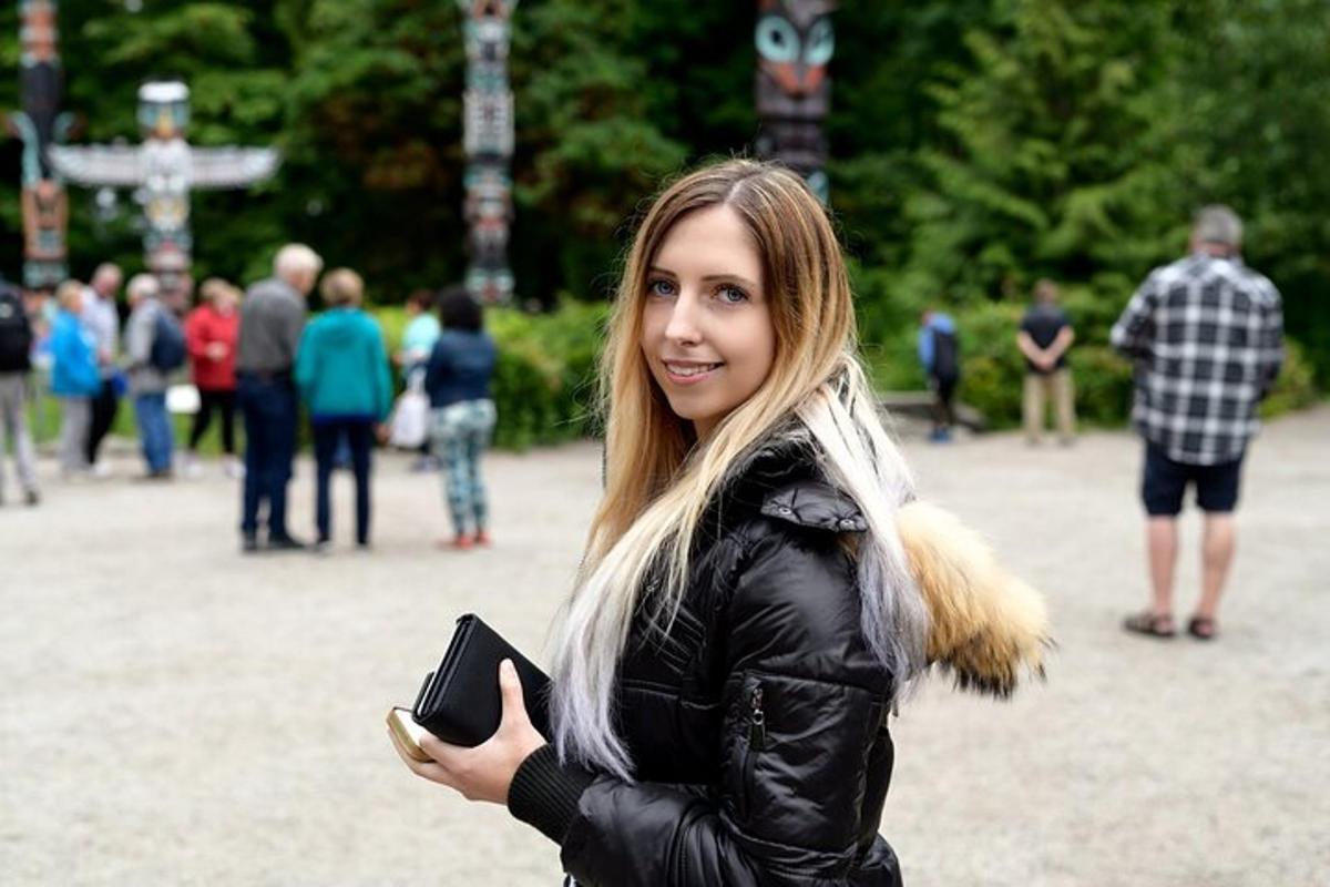 a woman in a black jacket holding a cell phone