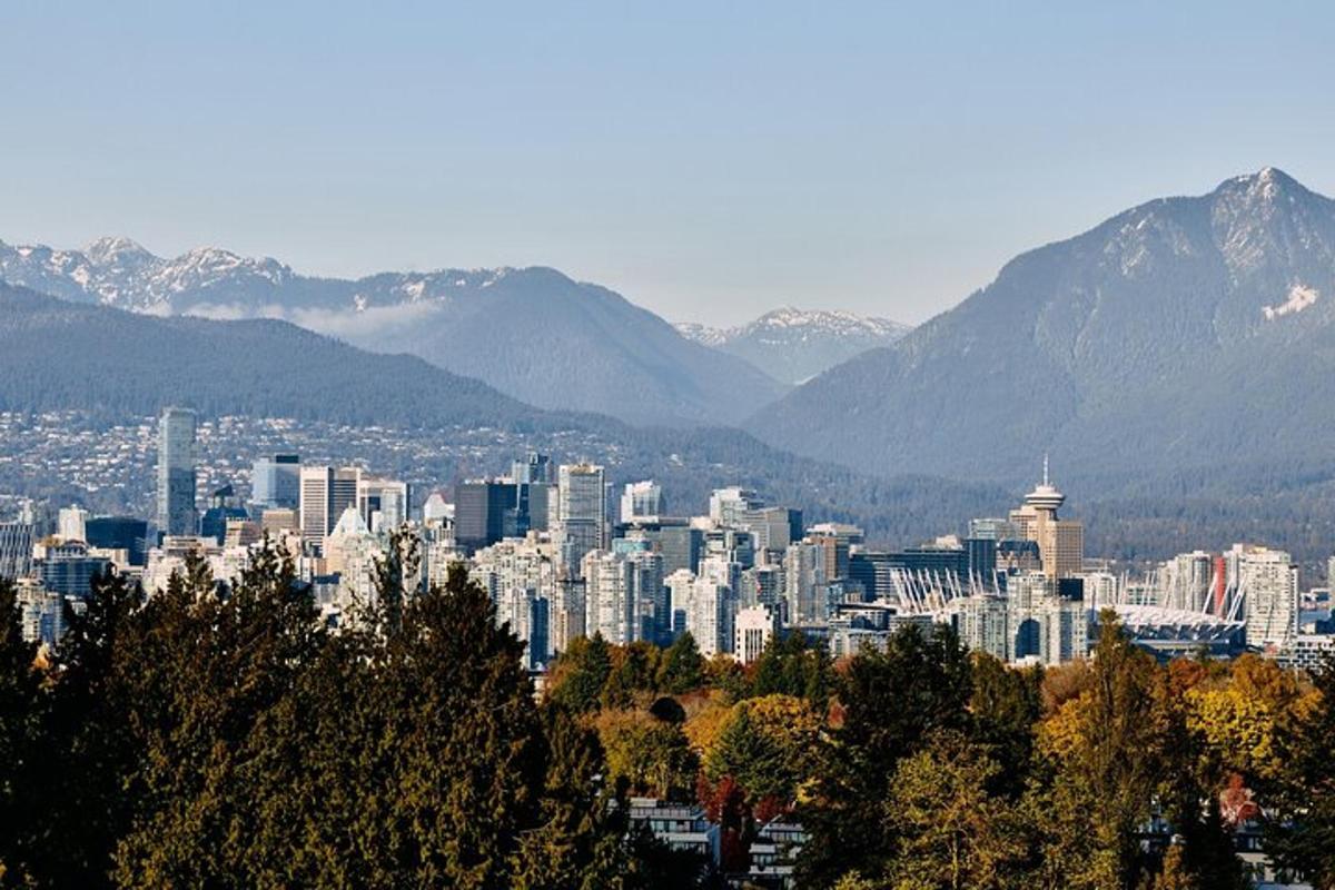 a cityscape of a city with mountains in the background