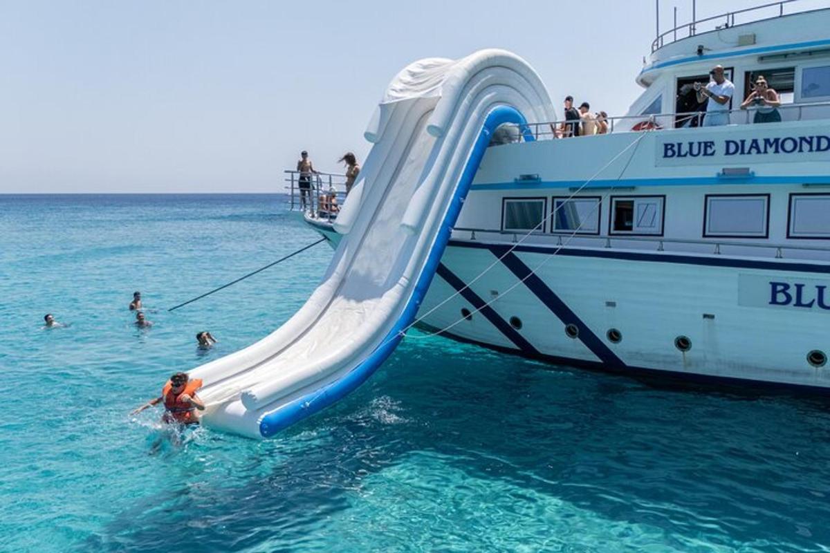 a group of people in the water next to a boat